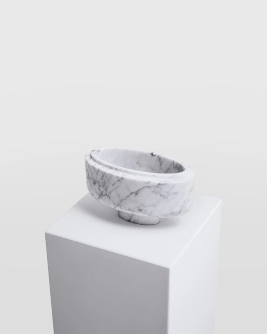 Zeina Bowl from premium Arabescato marble on a white pedestal against a light gray background