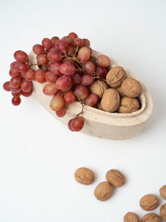 The Zeina Bowl filled with red grapes and walnuts, placed on a white surface for a refined, minimalist aesthetic.