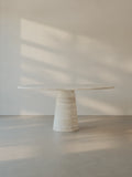 Leila Table in Roman travertine with a monolithic cone base