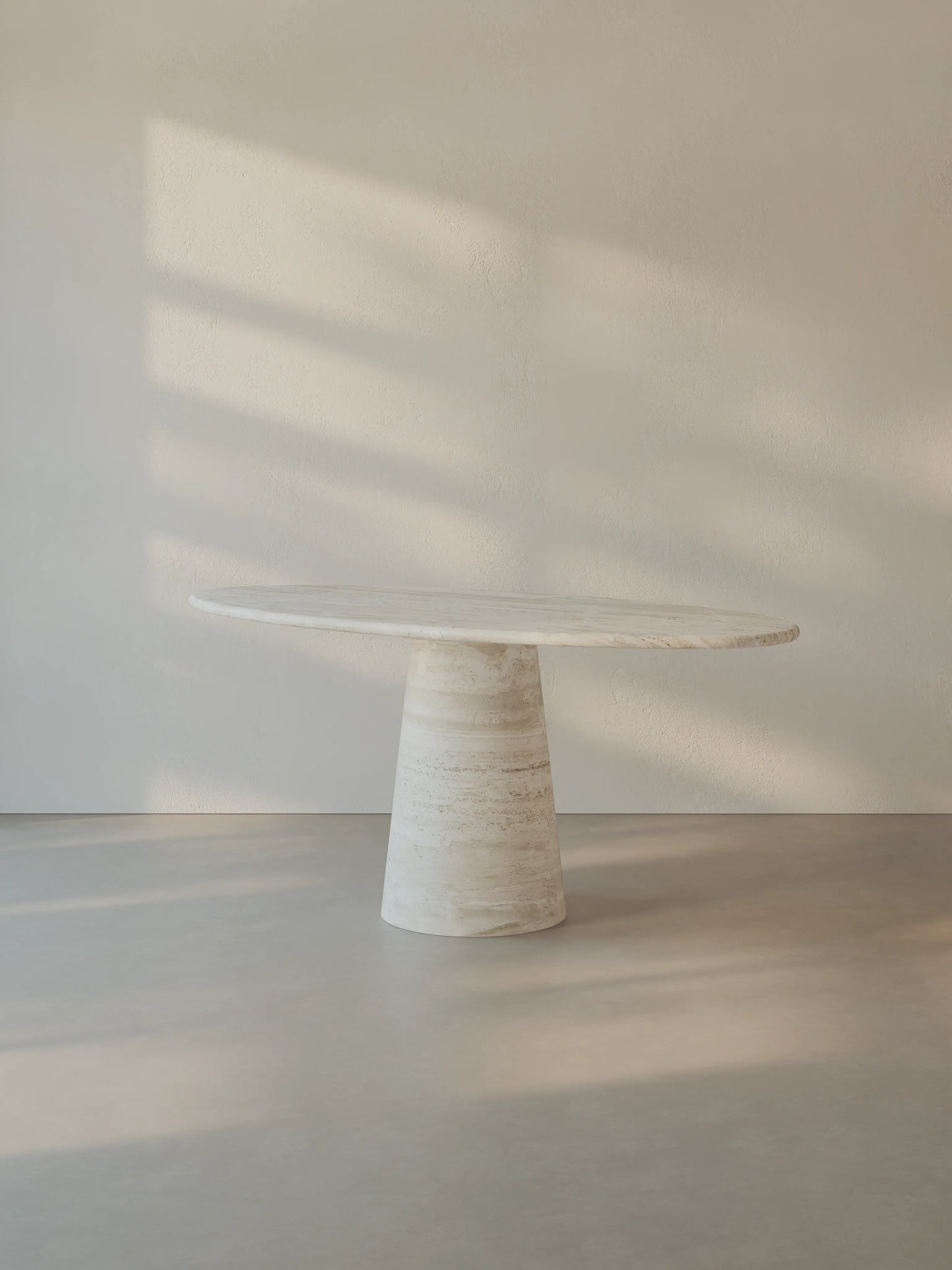 Leila Table crafted from Roman travertine, shown from a side angle