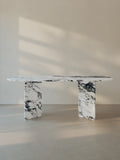 Sienae Dining Table in Arabescato Corchia marble with oval-edged tabletop and sculptural V-shaped base