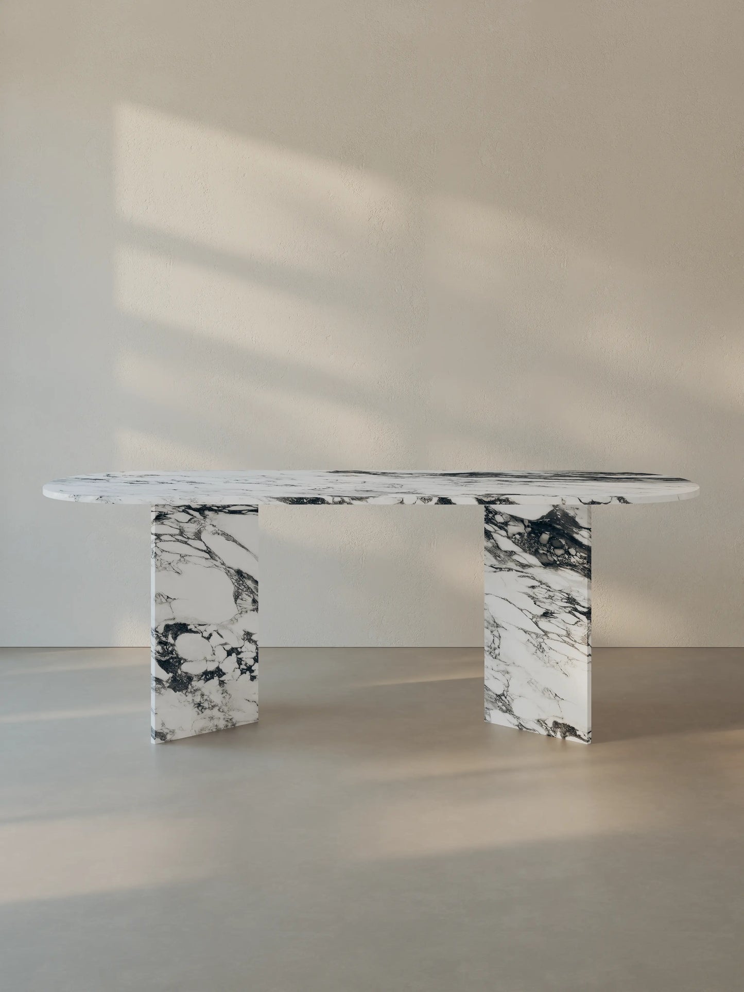Sienae Dining Table in Arabescato Corchia marble with oval-edged tabletop and sculptural V-shaped base