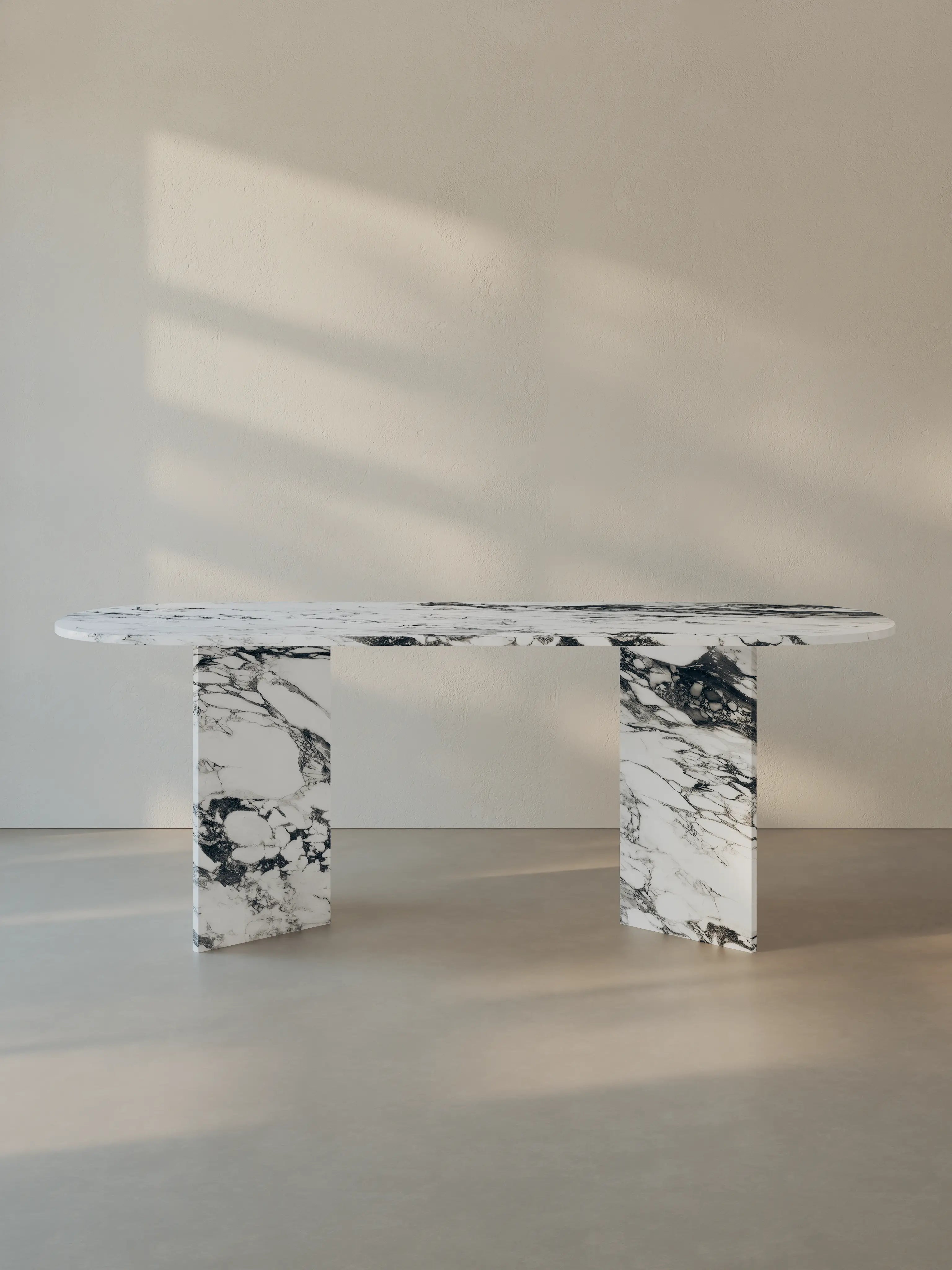 Sienae Dining Table in Arabescato Corchia marble with oval-edged tabletop and sculptural V-shaped base