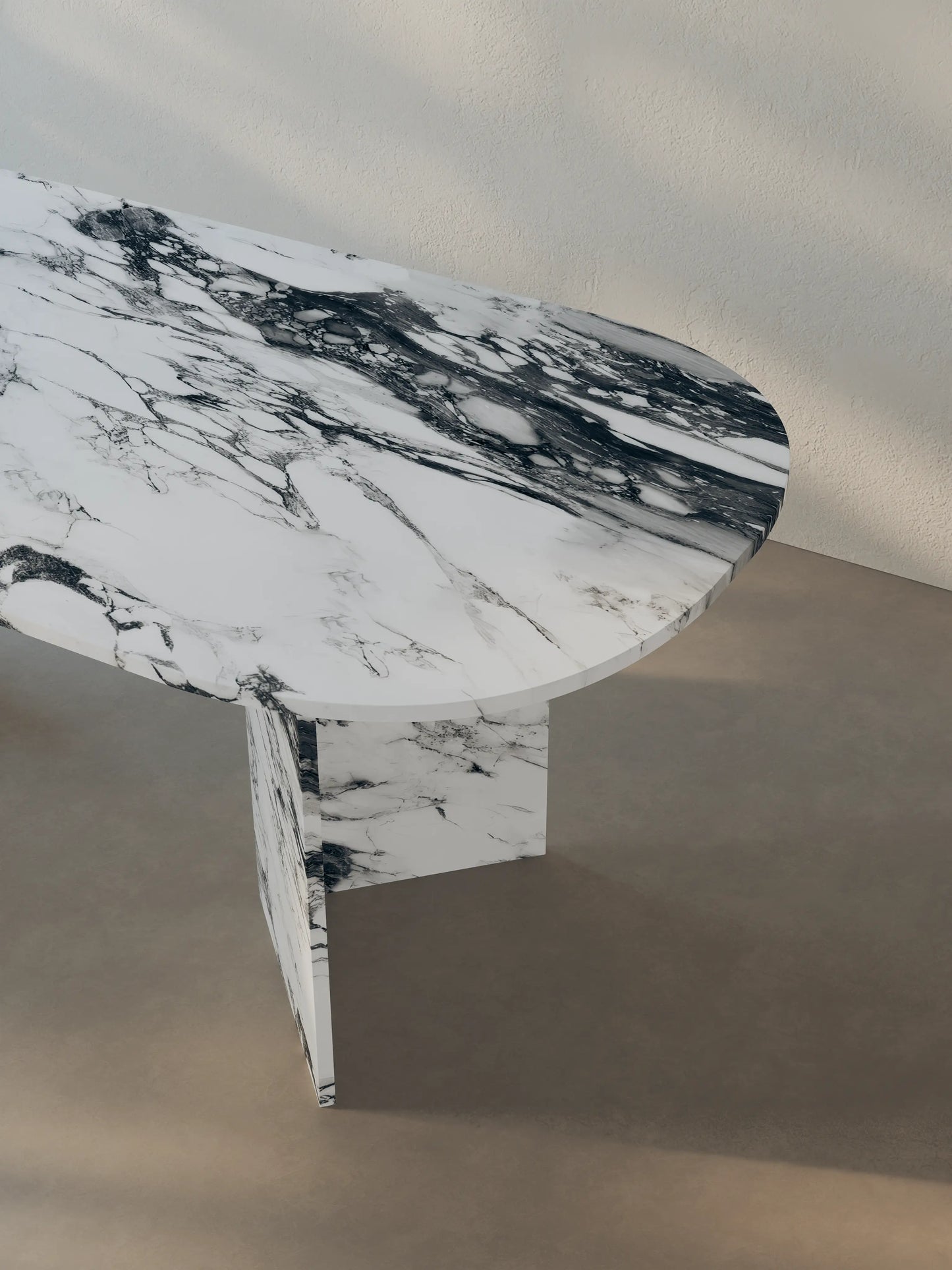 Detail of Sienae Dining Table in Arabescato Corchia marble showing oval-edged tabletop and V-shaped base