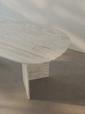 Detail view of the oval-edged tabletop of the Sienae Dining Table in Navona Travertine