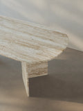 Detail view of the Sienae Dining Table in Roman Travertine, highlighting the oval-edged tabletop and natural stone surface.