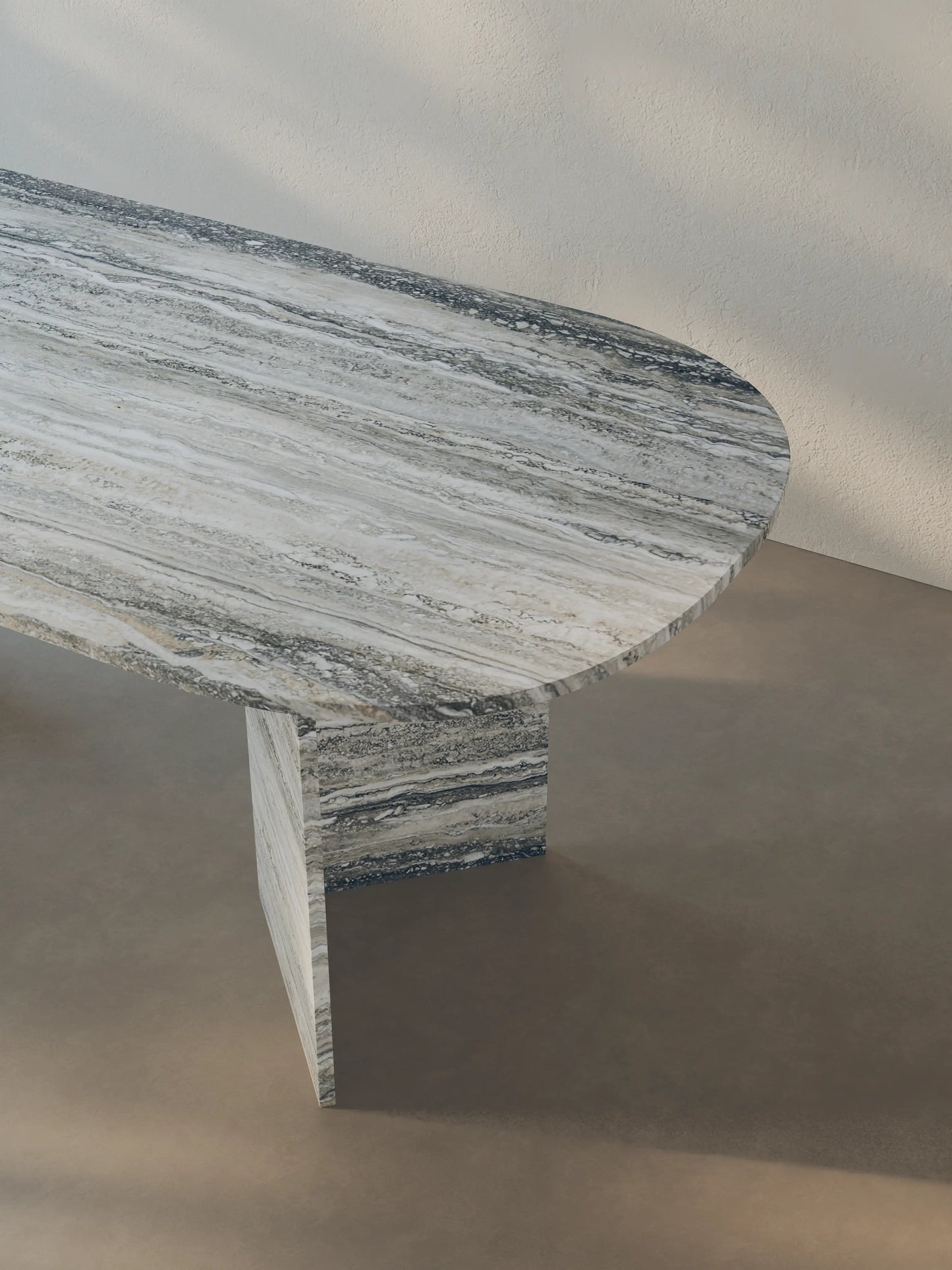 Detail view of the Sienae Dining Table in Silver Travertine, focusing on the oval-edged tabletop and natural horizontal veining.