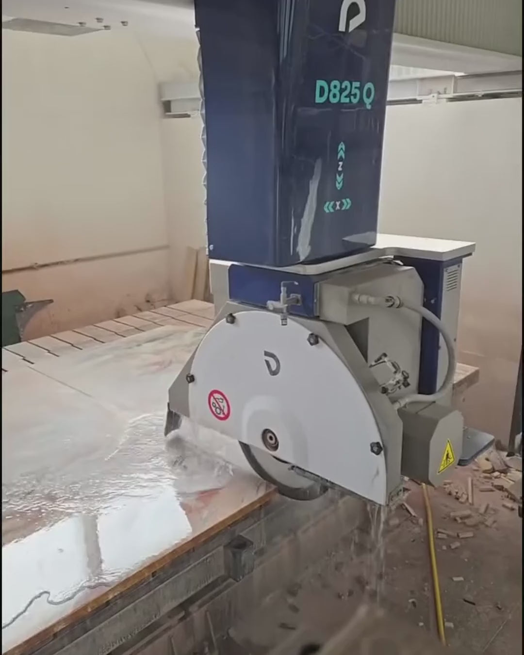 Rosso Orobico marble tabletop being shaped with CNC machinery