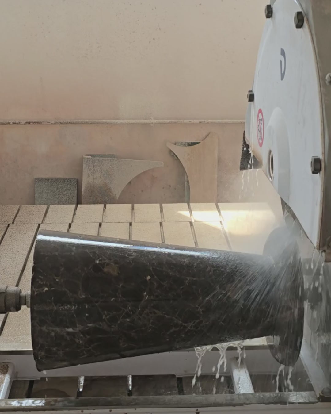Dark Emperador marble base element being machined