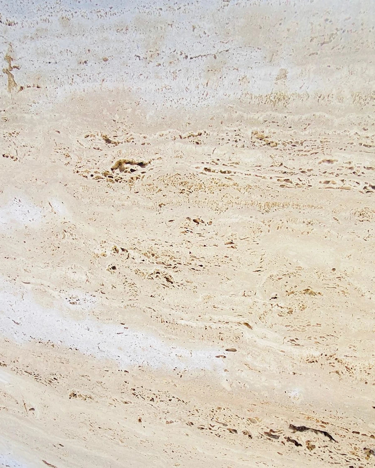 Roman Travertine sample with warm ivory tones and natural linear movement