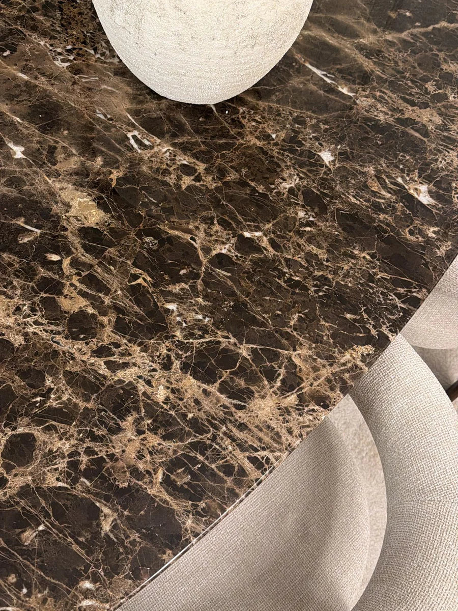 Dark Emperador marble tabletop with visible edge and natural veining