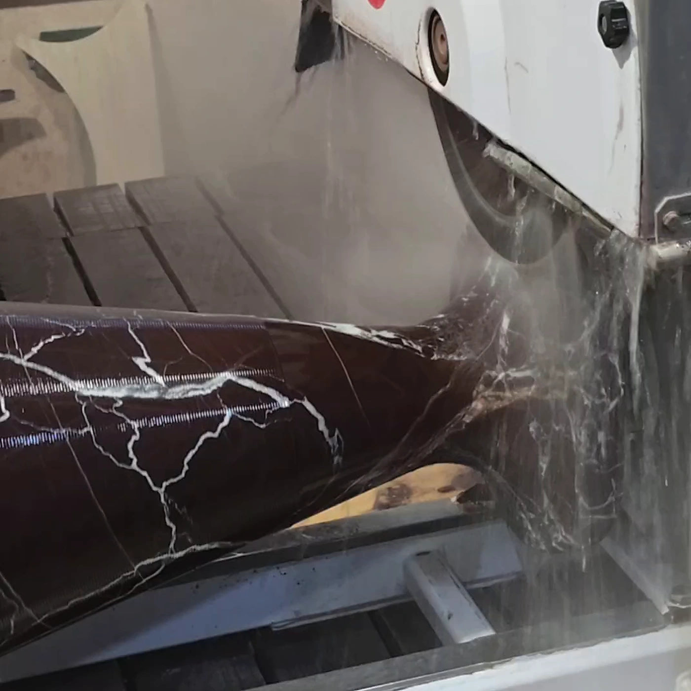 Rosso Levanto marble table base being cut and shaped in the workshop