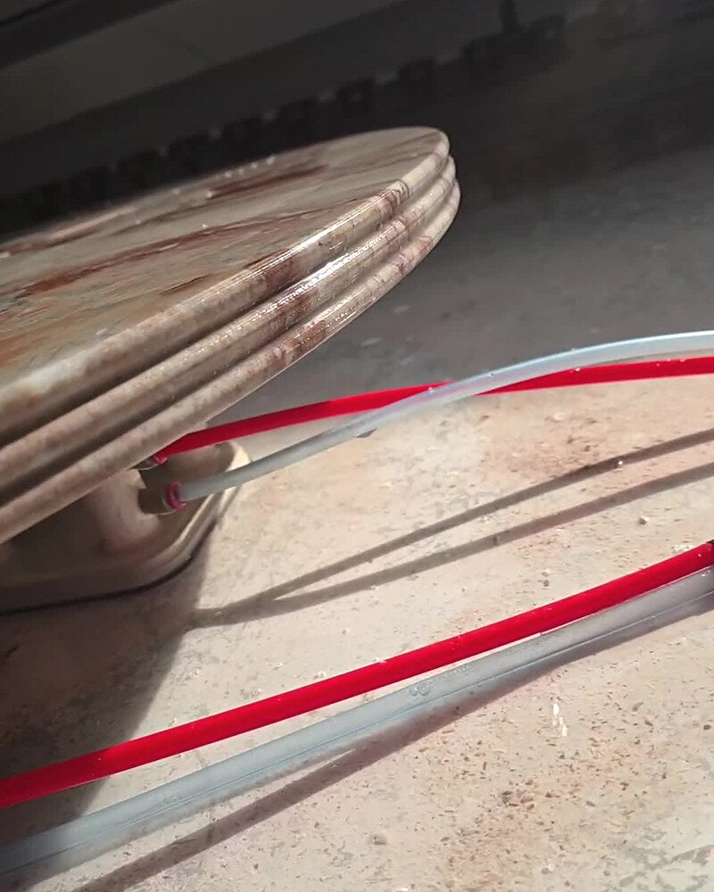 Close-up of a triple-bullnose marble tabletop edge profile.